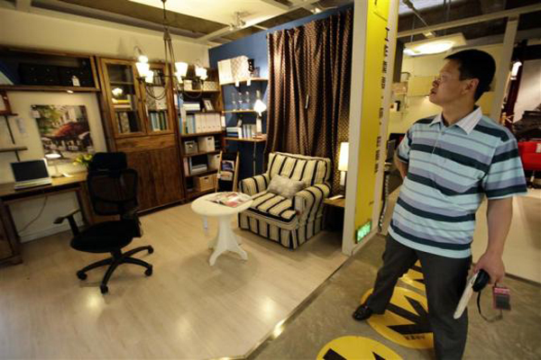 12 a-customer-looks-at-the-placement-of-study-room-at-an-11-furniture-store-in-kunming.jpg
