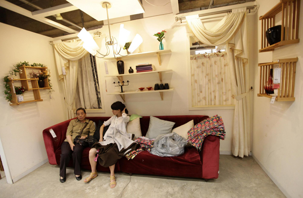 13 customers-rest-on-a-couch-at-the-11-furniture-store-in-kunming-southwest-chinas-yunnan-province.jpg