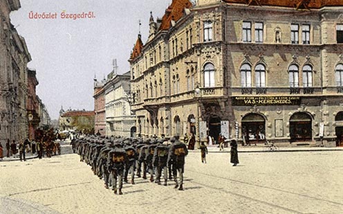 Ők már kimehettek a városba… Katonák masíroznak Szeged belvárosában a XX. század elején egy korabeli képeslapon